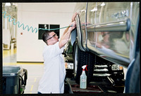 Associate Charles Gilliam works to process a vehicle during Westlake’s grand opening in 2003.